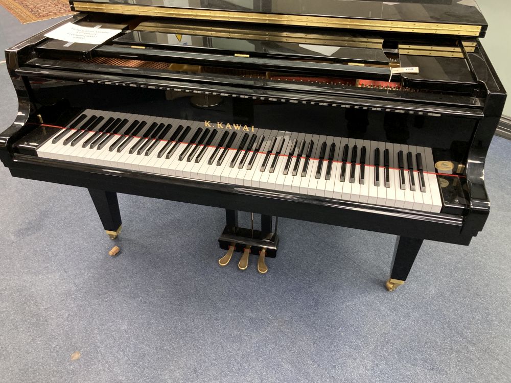 A Kawai baby grand piano, in a bright polyester finish case, on square tapered legs, together with matching adjustable stool